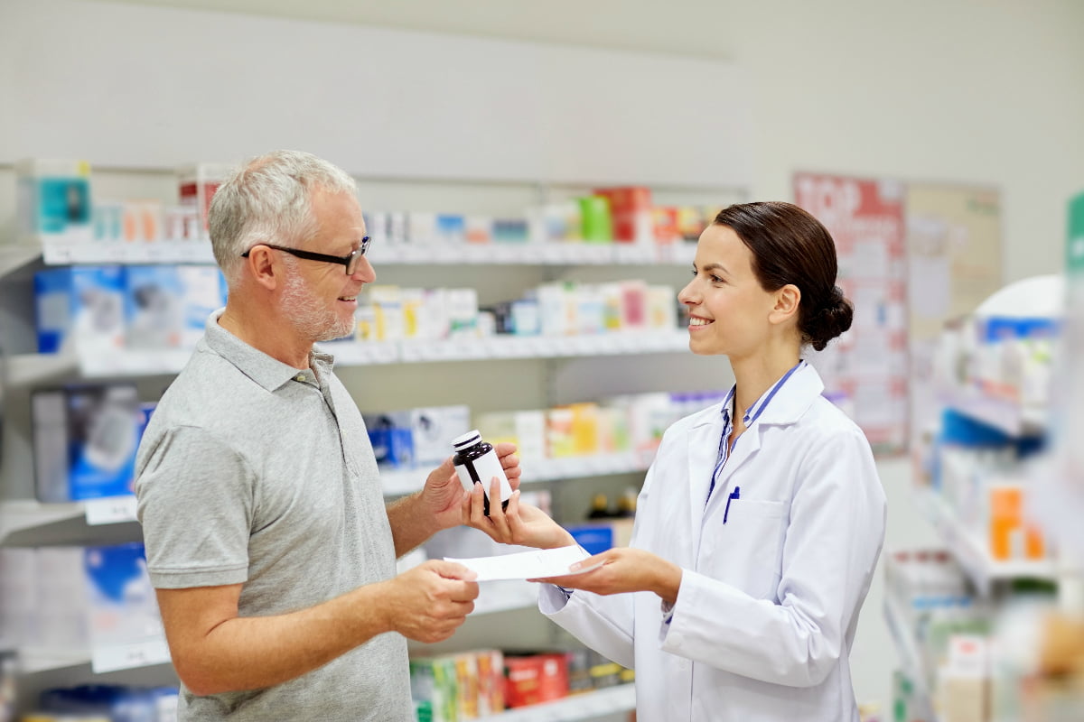 Pharmacist discusses with customer